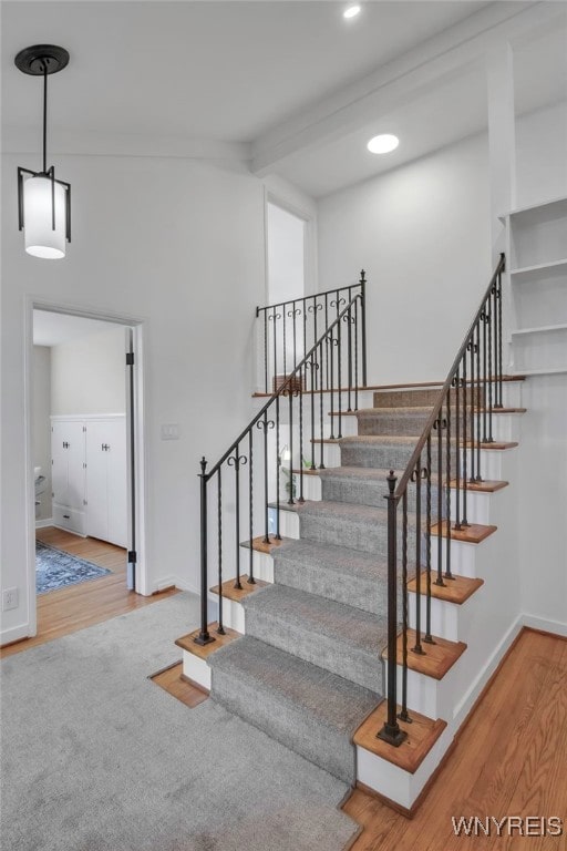 stairs with baseboards, recessed lighting, and wood finished floors