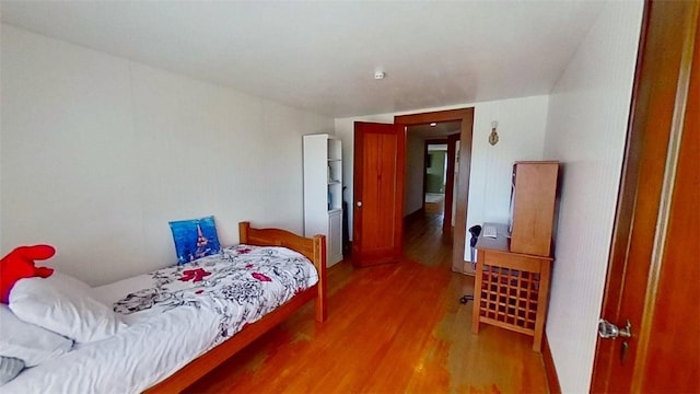 bedroom with wood finished floors