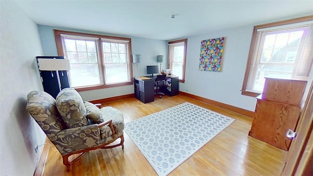 home office with baseboards and light wood finished floors