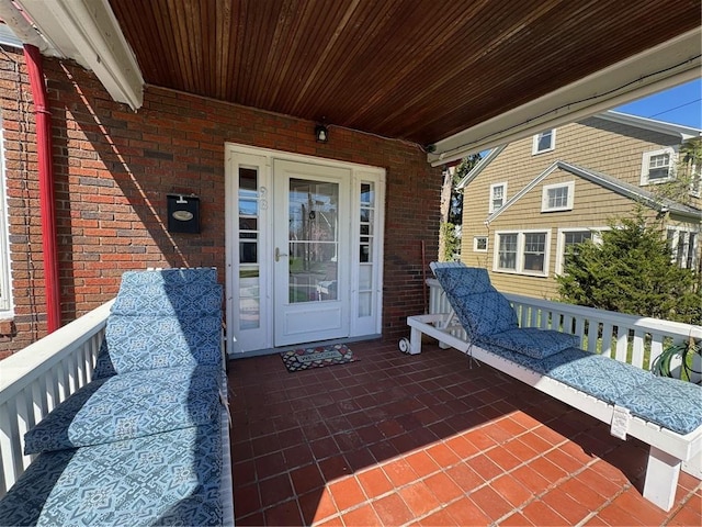view of exterior entry featuring brick siding