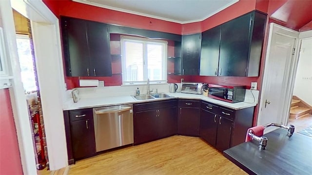 kitchen with black microwave, a sink, light wood-style floors, light countertops, and dishwasher