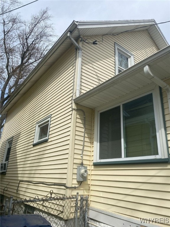view of side of home with fence