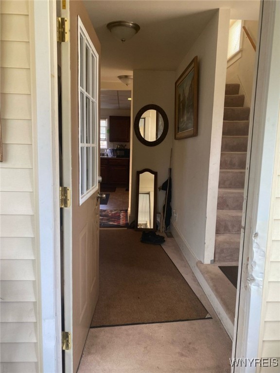corridor with stairway and carpet flooring