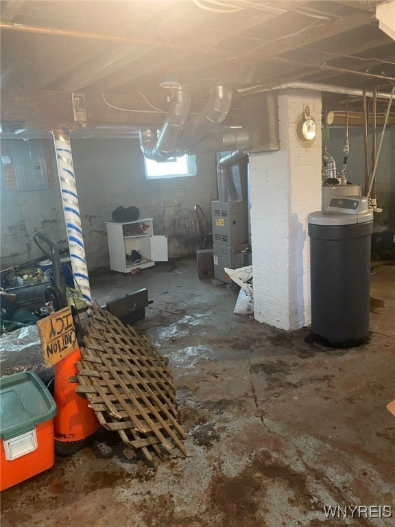 basement featuring heating unit and electric panel