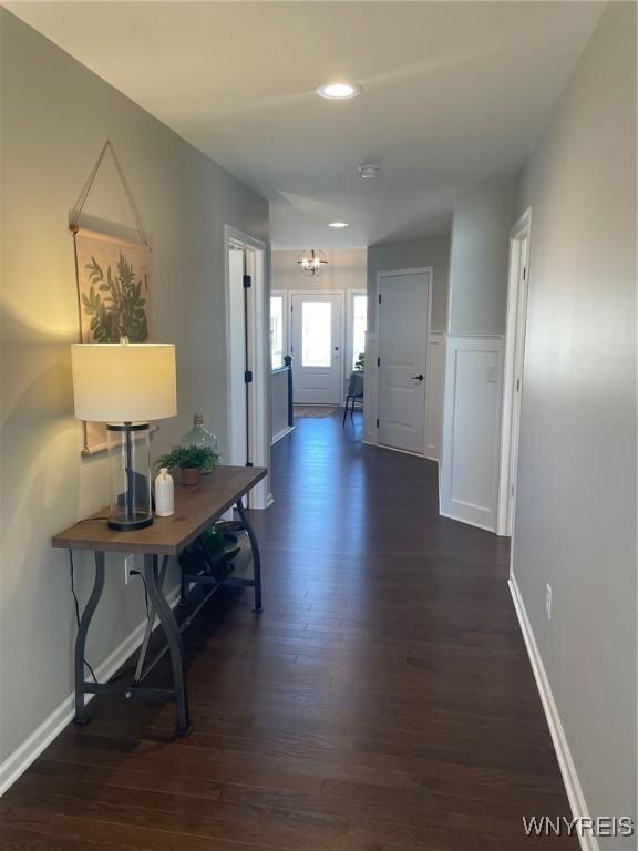 corridor featuring recessed lighting, baseboards, and dark wood finished floors