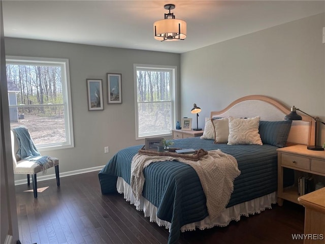 bedroom featuring baseboards and wood-type flooring