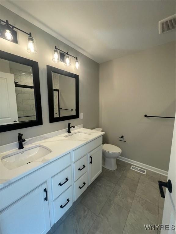 full bath with a sink, toilet, and visible vents