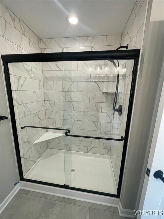 full bath with baseboards and a stall shower