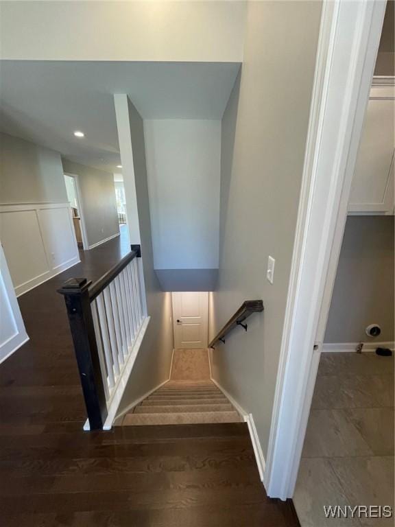 stairs with baseboards and wood finished floors