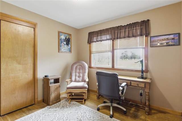 office area with baseboards and wood finished floors