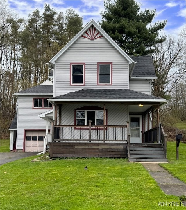view of front of house with an attached garage, a front yard, a porch, and aphalt driveway