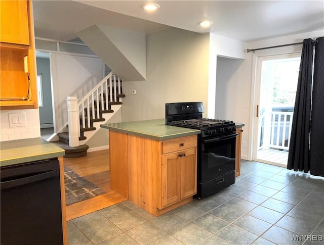 kitchen featuring recessed lighting, black appliances, and stainless steel countertops