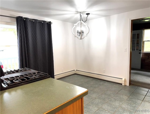 unfurnished dining area featuring an inviting chandelier and a baseboard heating unit