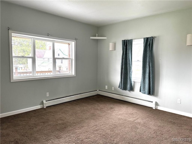 unfurnished room with baseboards, baseboard heating, and dark colored carpet