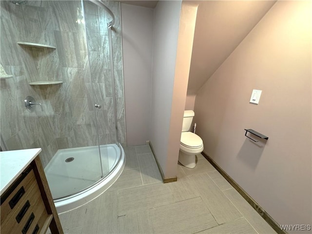 bathroom with toilet, tile patterned floors, a shower stall, and vanity