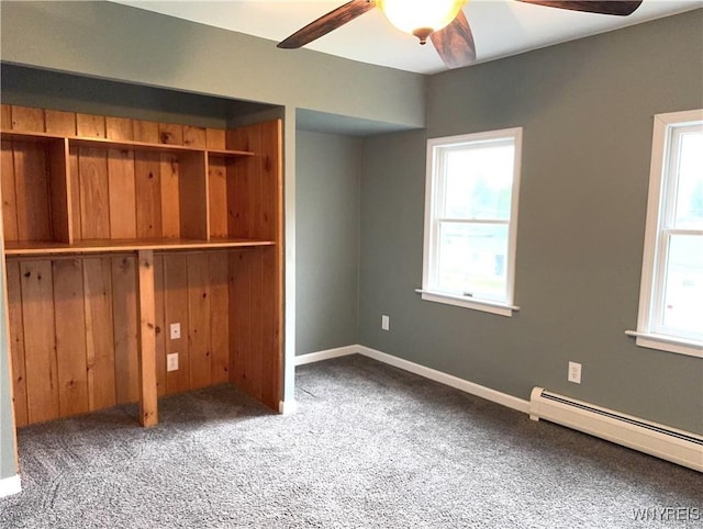 unfurnished bedroom featuring a ceiling fan, baseboard heating, carpet, and a closet