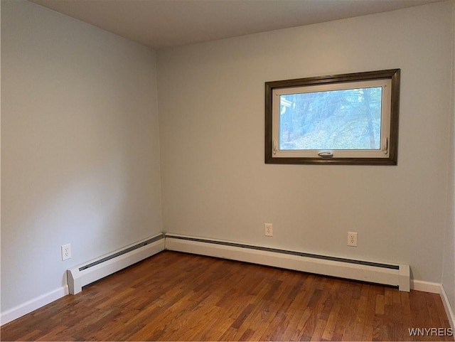 unfurnished room featuring baseboards and wood finished floors