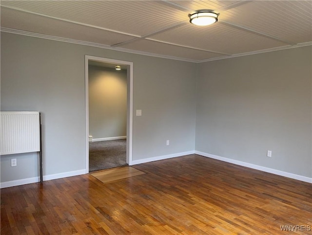 unfurnished room featuring baseboards, ornamental molding, radiator, and hardwood / wood-style floors