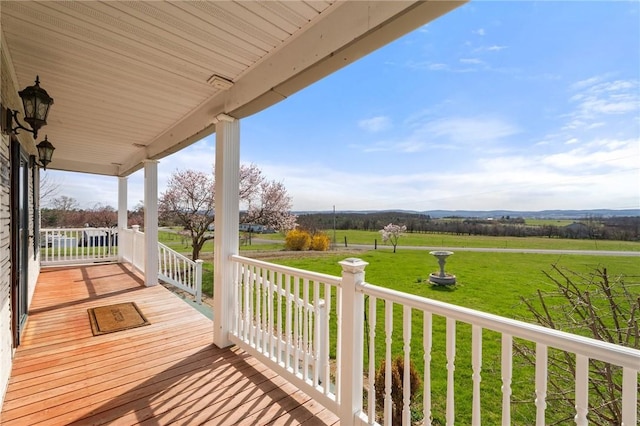 3300 County Road 7, Hector, NY 14865 - wooden deck featuring a porch, a lawn, and a rural view