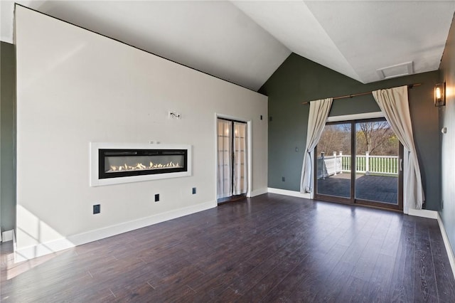 3300 County Road 7, Hector, NY 14865 - unfurnished living room with high vaulted ceiling, dark wood-type flooring, attic access, and baseboards