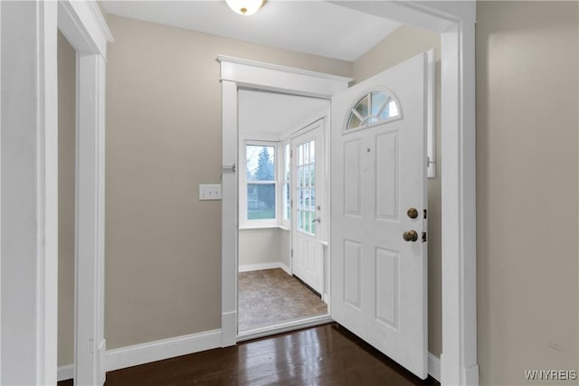 entryway with baseboards and dark wood-style flooring