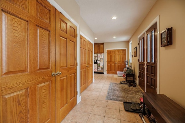 corridor featuring light tile patterned flooring and recessed lighting