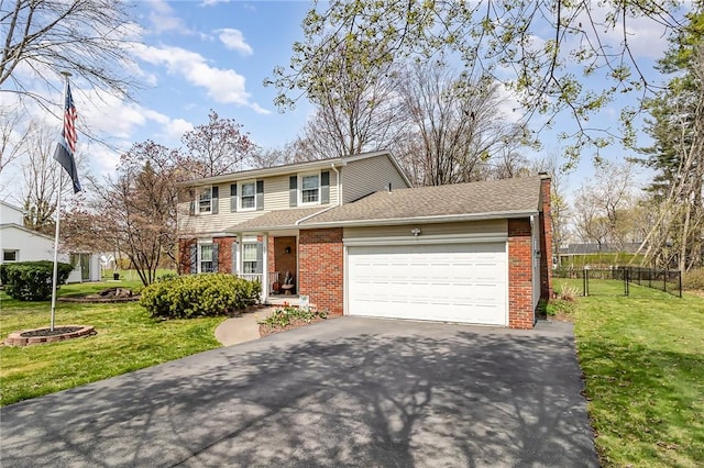traditional-style house featuring brick siding, an attached garage, fence, and driveway