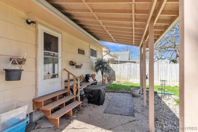 view of patio featuring entry steps and fence