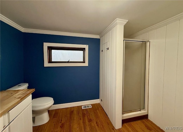 full bath featuring visible vents, vanity, wood finished floors, toilet, and a stall shower