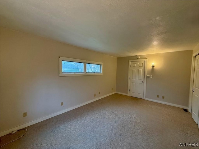 empty room with baseboards and light colored carpet
