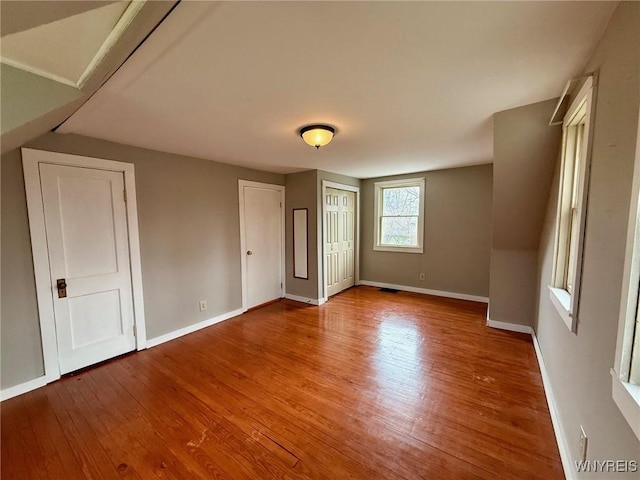 interior space featuring baseboards and wood finished floors