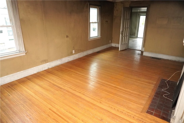 empty room featuring baseboards and wood finished floors