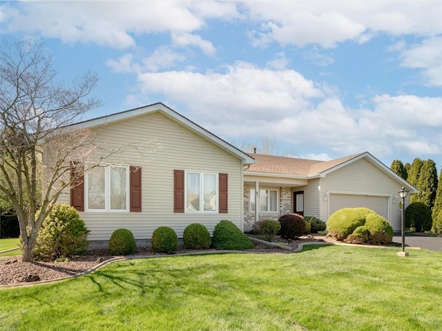 ranch-style home with an attached garage, driveway, and a front yard