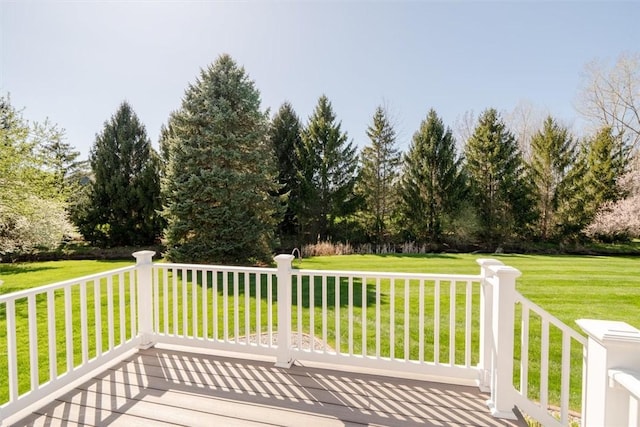 wooden terrace featuring a lawn