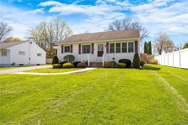 view of front of home with fence and a front lawn