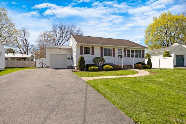 view of front of property featuring an attached garage, a front lawn, aphalt driveway, and fence