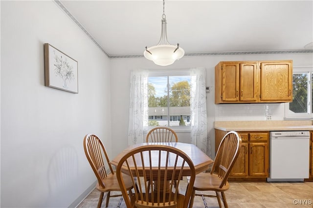 dining space with crown molding