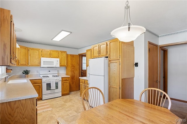 kitchen featuring crown molding, pendant lighting, a sink, light countertops, and white appliances