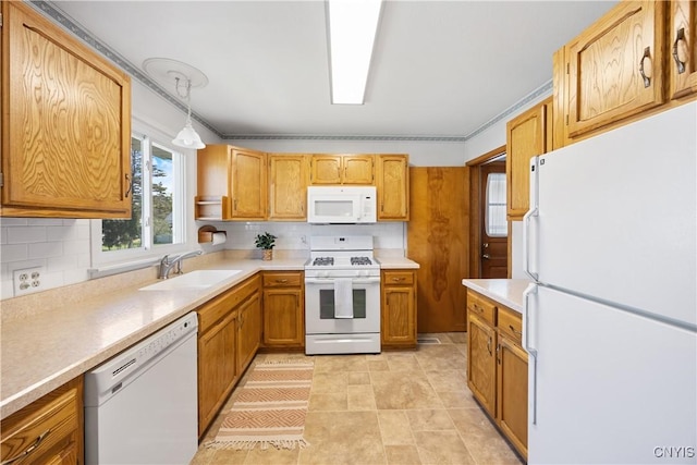 kitchen with a sink, backsplash, white appliances, and light countertops