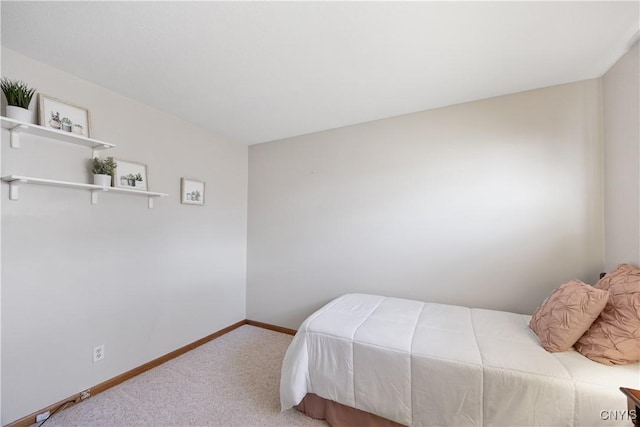 bedroom featuring carpet floors and baseboards