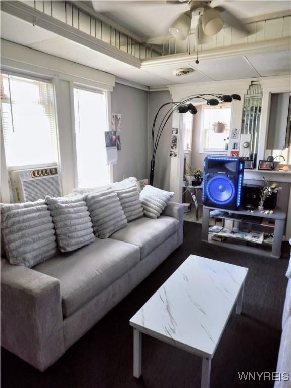 living area with cooling unit and a ceiling fan