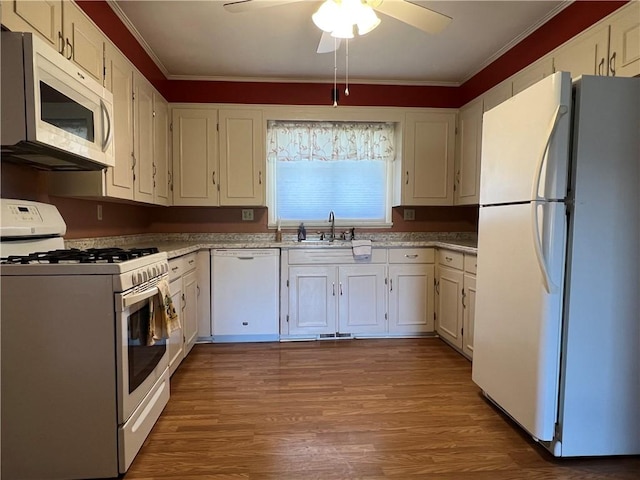 kitchen with a ceiling fan, crown molding, a sink, white cabinets, and white appliances