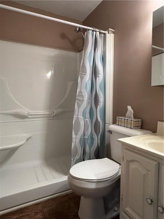 bathroom with vanity, a stall shower, and toilet