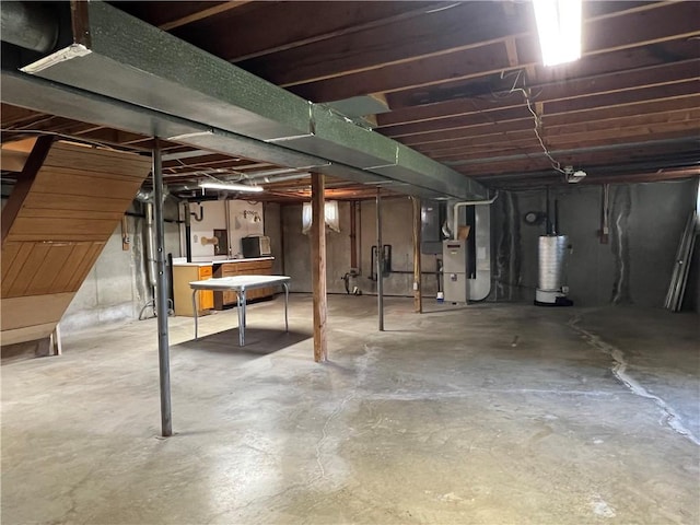 unfinished below grade area with heating unit and gas water heater