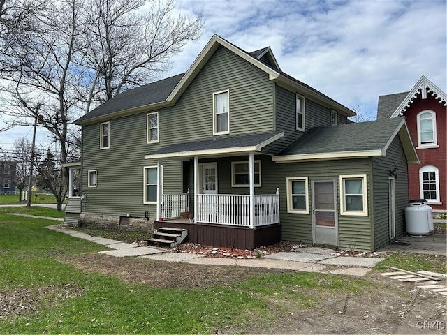 11931 State Route 12e, Lyme, NY 13622 - rear view of property featuring a porch, a yard, and a shingled roof