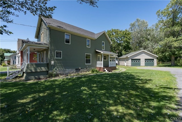 11931 State Route 12e, Lyme, NY 13622 - view of front of home featuring a garage, an outdoor structure, covered porch, and a front yard
