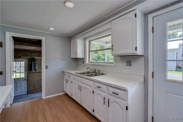 11931 State Route 12e, Lyme, NY 13622 - kitchen featuring white cabinets, light wood-style flooring, light countertops, and plenty of natural light