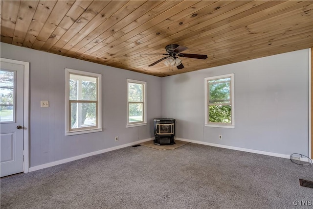 11931 State Route 12e, Lyme, NY 13622 - unfurnished room with a wood stove, wooden ceiling, carpet, and ceiling fan