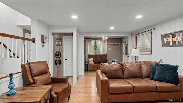 living area with stairs, recessed lighting, and light wood-style flooring