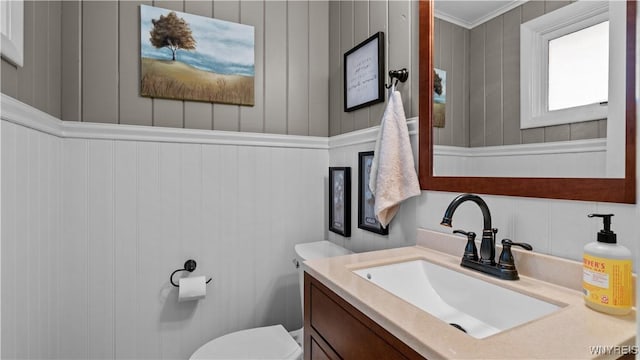 half bathroom with toilet and vanity